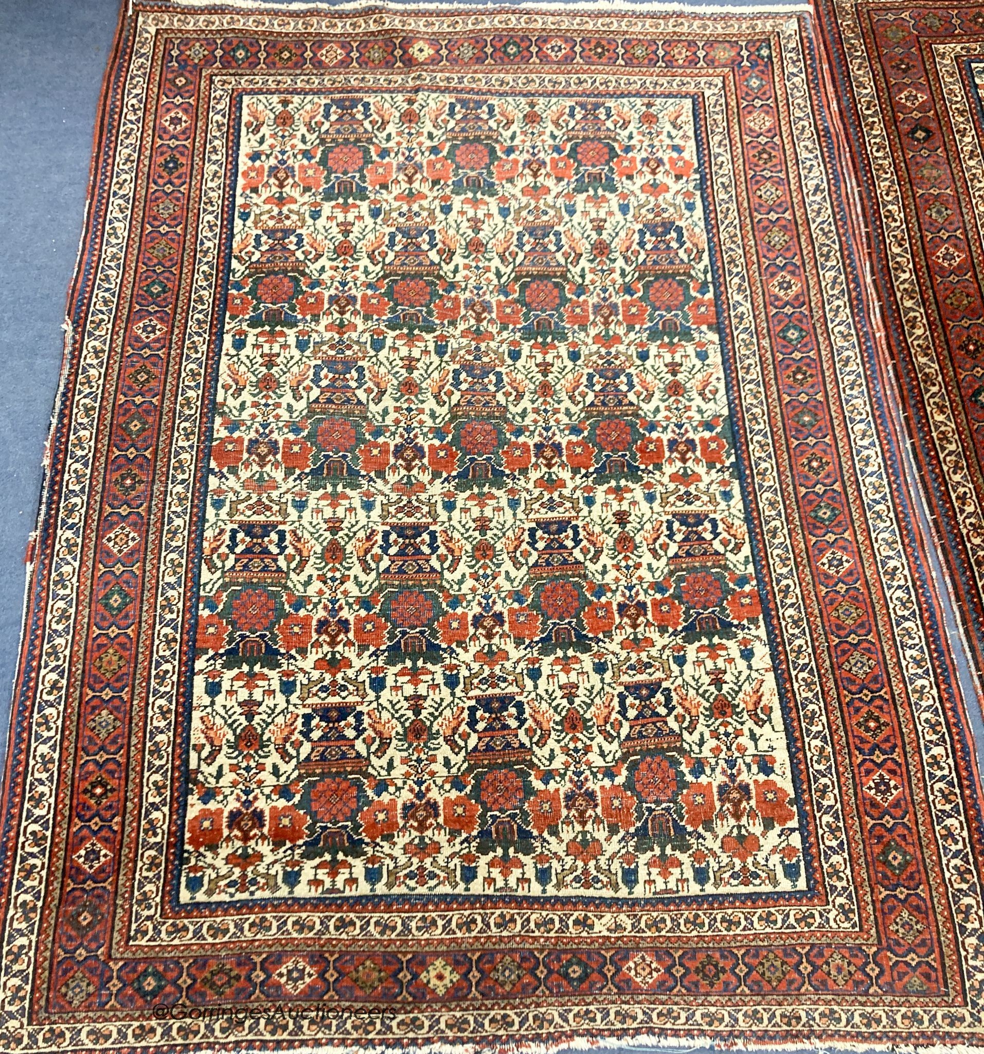 A pair of early 20th century North West Persian ivory ground rugs, woven with birds and vases of flowers, 150 x 110cm